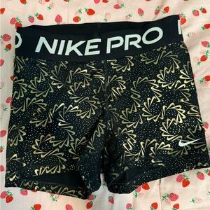 women’s black and gold nike pros 3”
